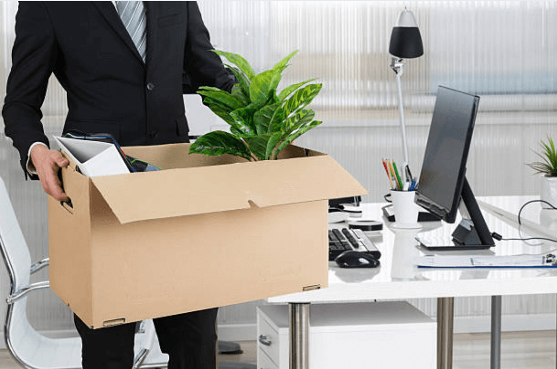 man holding box with office items