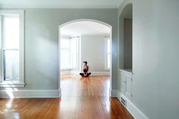 Woman sitting in an empty house